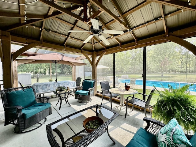 unfurnished sunroom featuring lofted ceiling and a ceiling fan