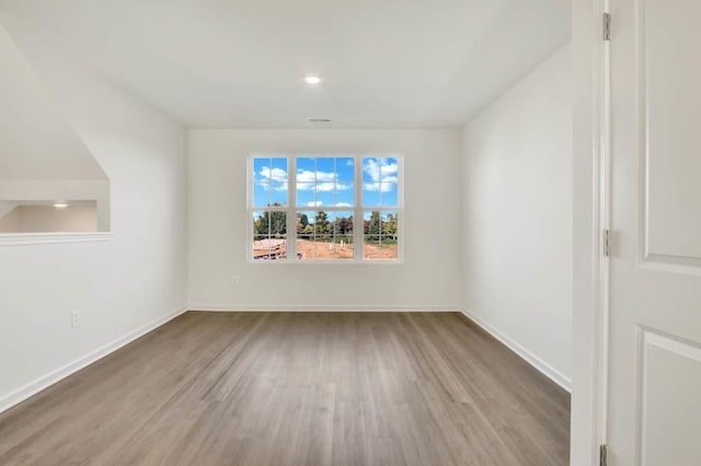 additional living space featuring light wood finished floors, visible vents, baseboards, and recessed lighting