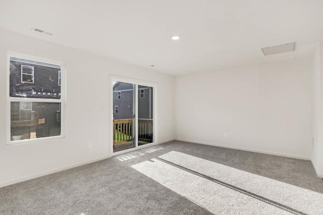 carpeted empty room with visible vents, baseboards, and recessed lighting