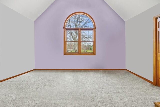 bonus room featuring carpet flooring, vaulted ceiling, and baseboards