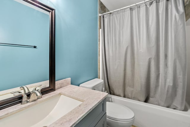 full bath with shower / tub combo, vanity, and toilet