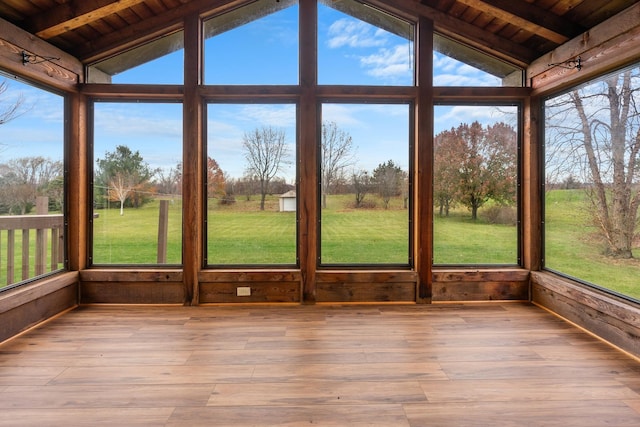 unfurnished sunroom with lofted ceiling with beams and wooden ceiling