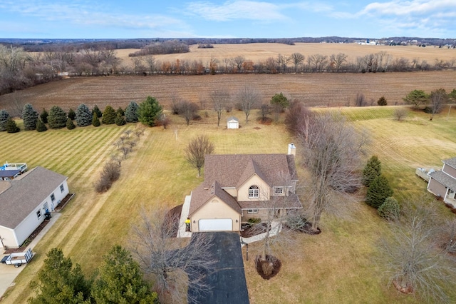 birds eye view of property with a rural view