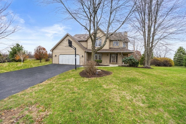 traditional-style house featuring a front lawn, a chimney, an attached garage, and aphalt driveway