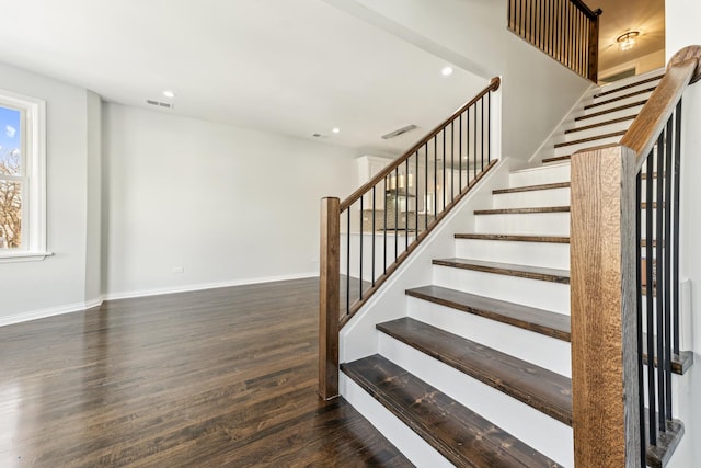 staircase featuring recessed lighting, visible vents, baseboards, and wood finished floors