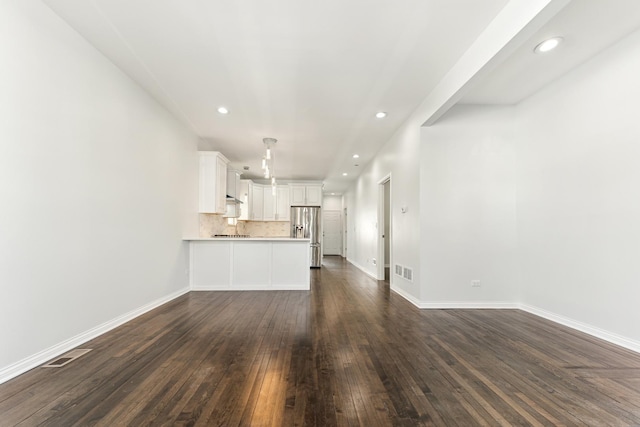 unfurnished living room with recessed lighting, visible vents, baseboards, and dark wood-style flooring