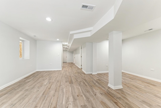 below grade area with recessed lighting, visible vents, baseboards, and light wood-style floors