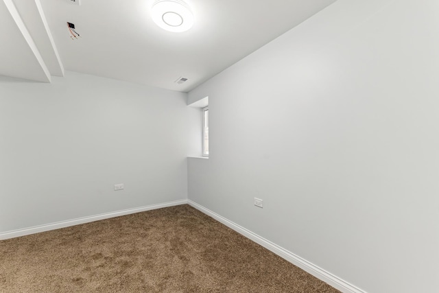 unfurnished room with visible vents, baseboards, and carpet flooring