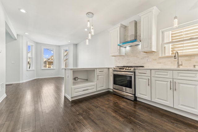 kitchen featuring tasteful backsplash, dark wood finished floors, gas stove, wall chimney exhaust hood, and white cabinets