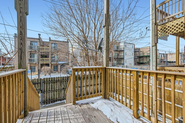 snow covered deck with fence