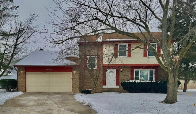 view of front of home featuring a garage, concrete driveway, and brick siding