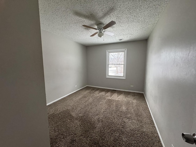 carpeted empty room featuring a textured ceiling, ceiling fan, and baseboards