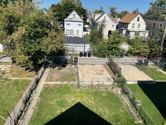 view of yard featuring fence and a residential view