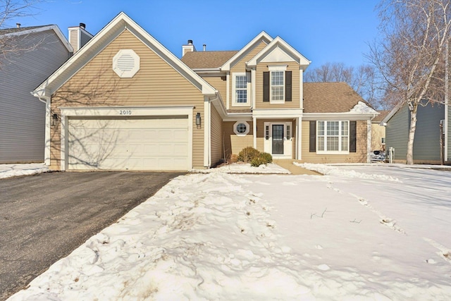 traditional home featuring driveway and an attached garage