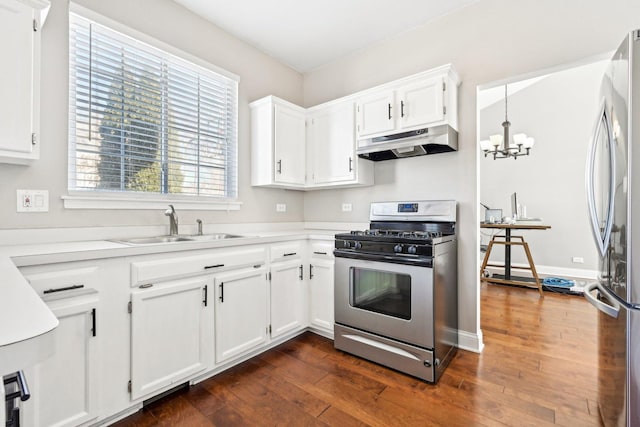 kitchen with dark wood-style flooring, stainless steel appliances, white cabinets, a sink, and under cabinet range hood