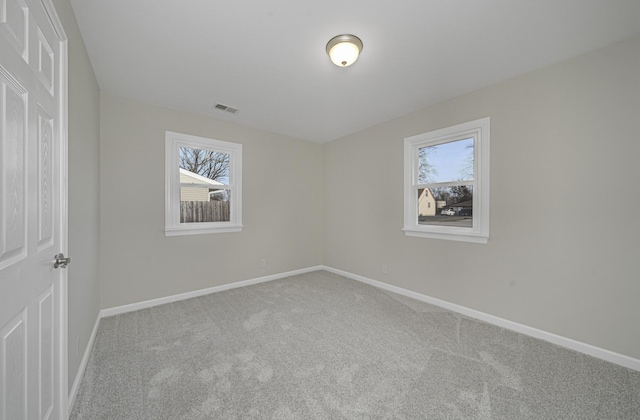 unfurnished bedroom with baseboards, visible vents, and carpet flooring