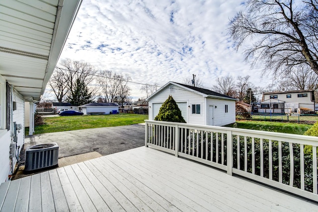 wooden terrace with central AC, an outdoor structure, a lawn, a residential view, and a trampoline