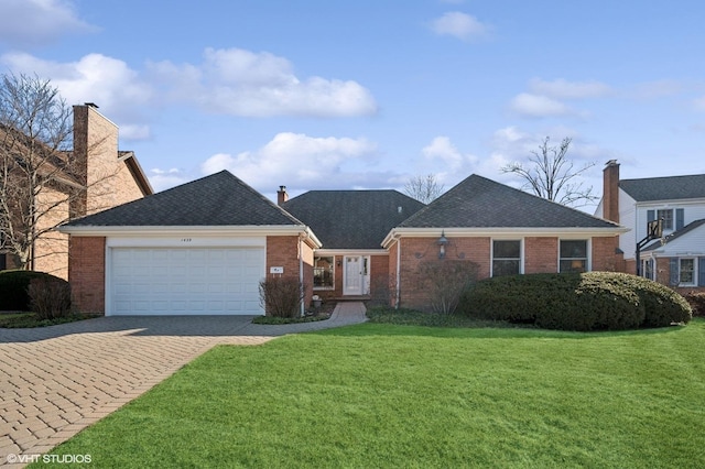 ranch-style house with decorative driveway, a front lawn, a garage, and brick siding