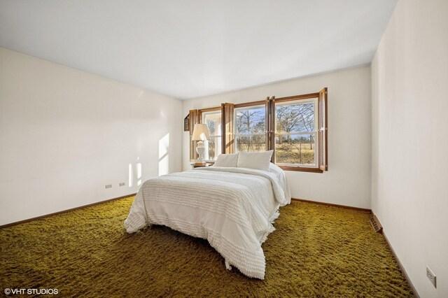 bedroom with baseboards and carpet floors