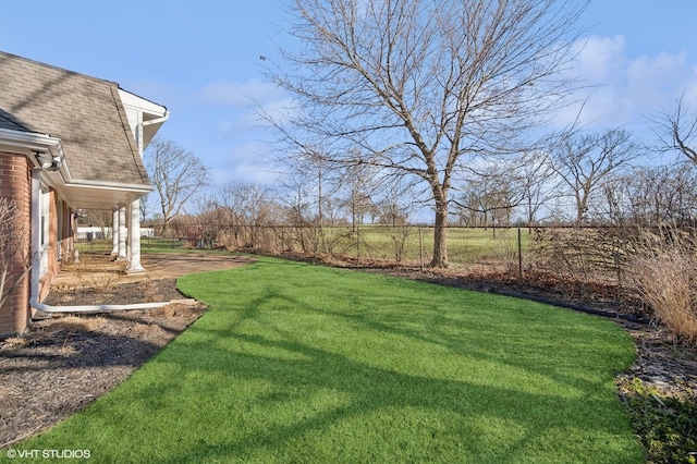 view of yard featuring a patio and fence