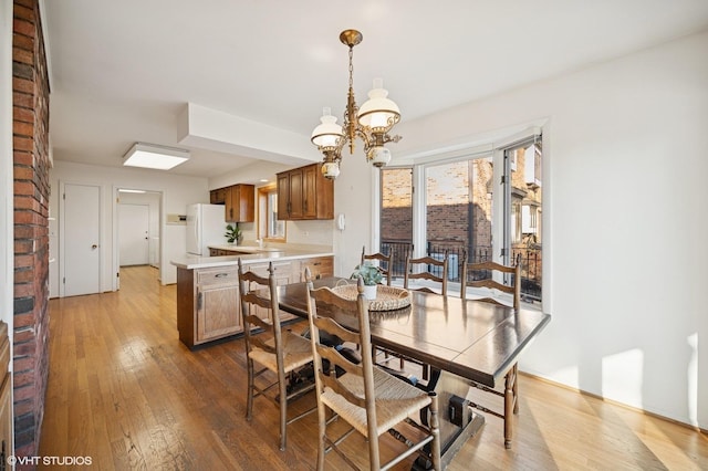 dining area with a notable chandelier and hardwood / wood-style floors