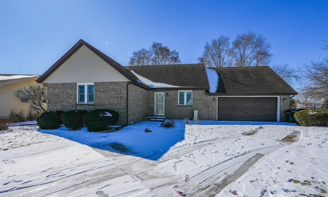 single story home with a garage and brick siding