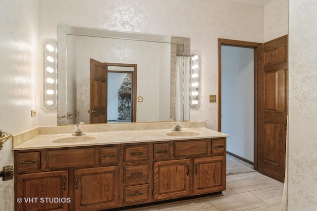 full bathroom featuring a sink and double vanity