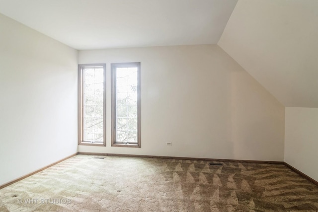 bonus room featuring carpet, baseboards, and vaulted ceiling