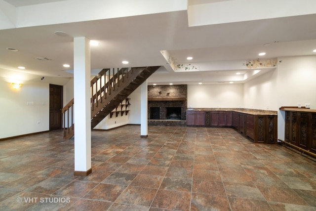 finished below grade area with stone finish floor, baseboards, stairway, and recessed lighting