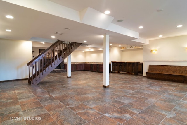 finished basement featuring recessed lighting, stairway, and baseboards