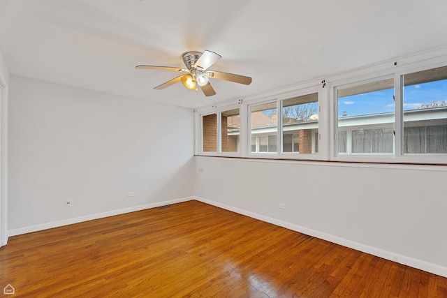 1652 W Jarvis Ave, Chicago, IL 60626 - unfurnished room with baseboards, plenty of natural light, and wood finished floors
