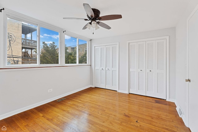 1652 W Jarvis Ave, Chicago, IL 60626 - unfurnished bedroom with visible vents, baseboards, multiple closets, and light wood-style flooring