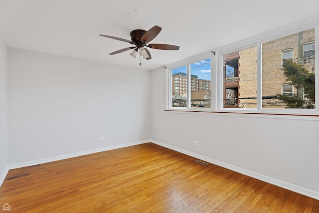 1652 W Jarvis Ave, Chicago, IL 60626 - unfurnished room featuring baseboards, a ceiling fan, and wood finished floors