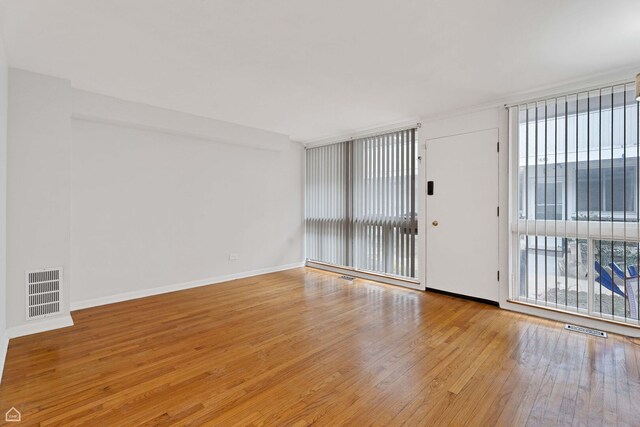 1652 W Jarvis Ave, Chicago, IL 60626 - empty room with visible vents, baseboards, and hardwood / wood-style flooring