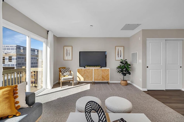 living area with visible vents and baseboards