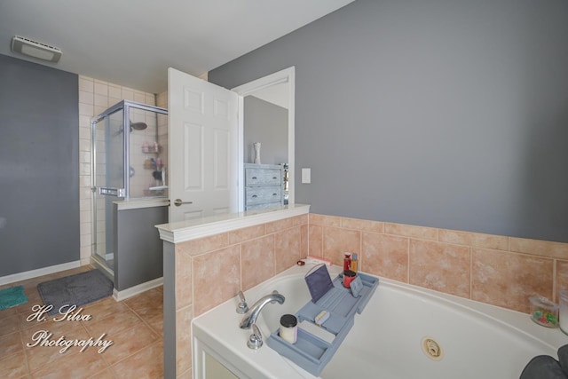 full bathroom with a garden tub, baseboards, a stall shower, and tile patterned floors