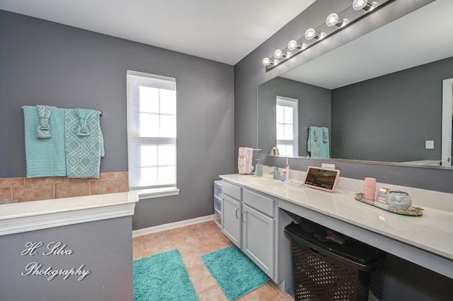 full bathroom with tile patterned flooring, vanity, and baseboards