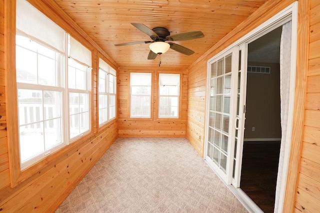 unfurnished sunroom featuring a ceiling fan, wood ceiling, and visible vents