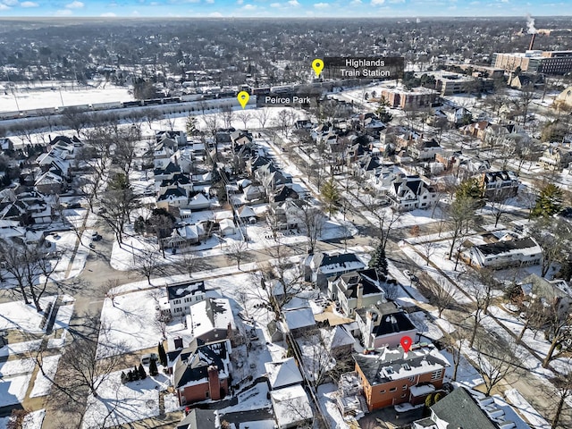 snowy aerial view with a residential view