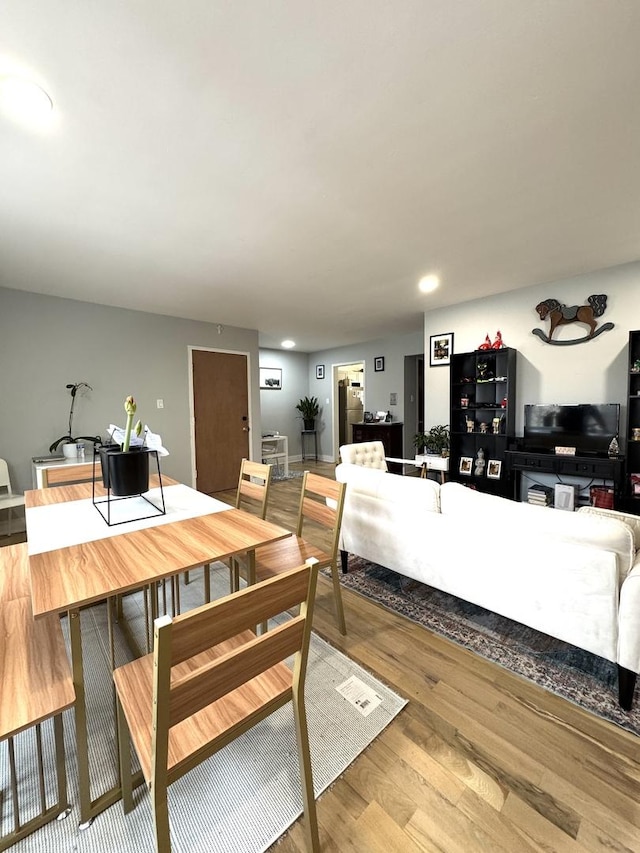 dining room with light wood-style flooring and recessed lighting