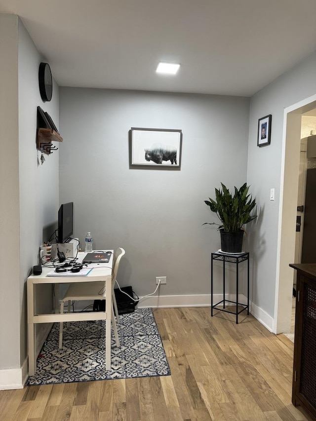 office area with light wood-type flooring and baseboards