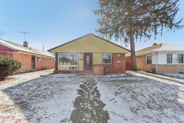 view of front of house with entry steps and brick siding