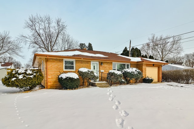 view of front of property featuring a garage and brick siding