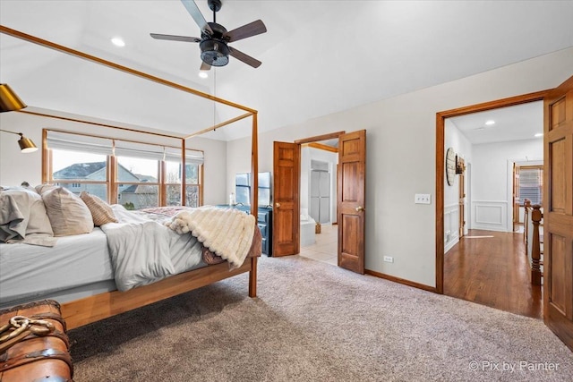 carpeted bedroom featuring lofted ceiling, a decorative wall, a ceiling fan, and recessed lighting