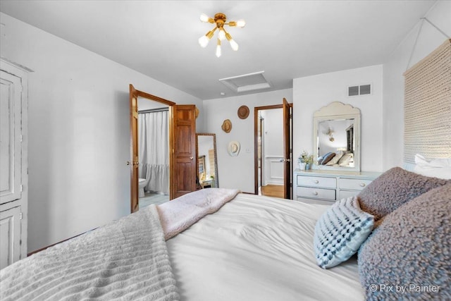 bedroom with attic access and visible vents