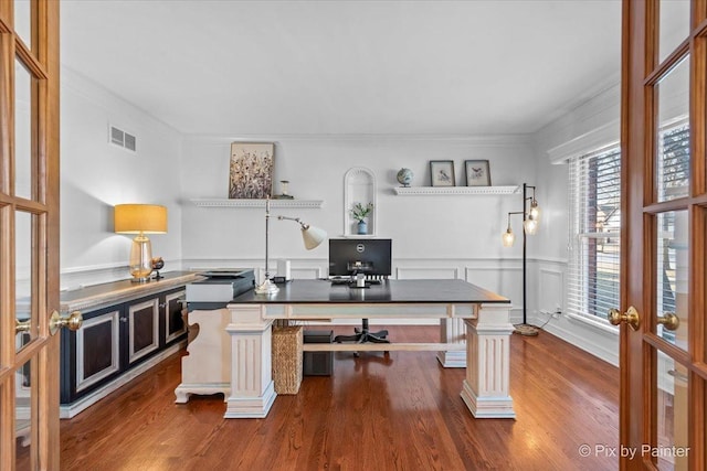 office space featuring french doors, wood finished floors, visible vents, and crown molding