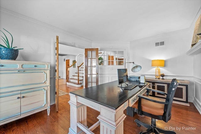 office with crown molding, visible vents, wood finished floors, and wainscoting