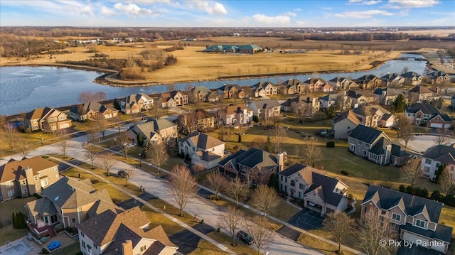 drone / aerial view featuring a water view and a residential view