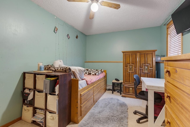 carpeted bedroom with baseboards, a ceiling fan, and a textured ceiling