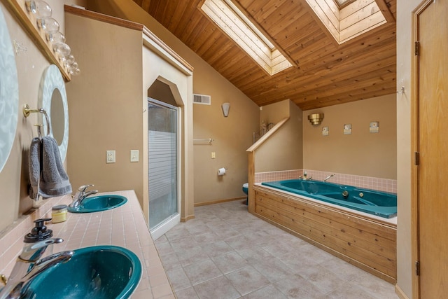 bathroom with a stall shower, visible vents, and a sink